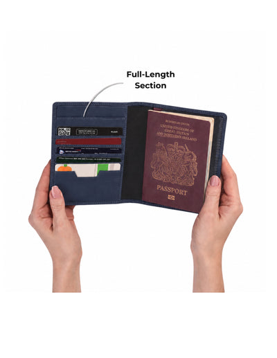A navy blue passport holder wallet shown open in two hands against a white background, with an arrow and text pointing to the interior card slots and noting a full-length section. A UK passport is visible inside.