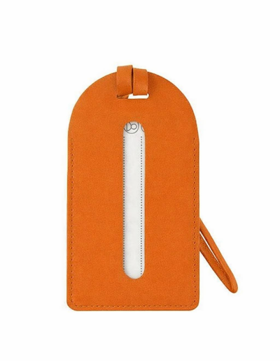 An orange leather luggage tag with a vertical white zipper and a matching orange wristlet strap, shown on a plain white background.