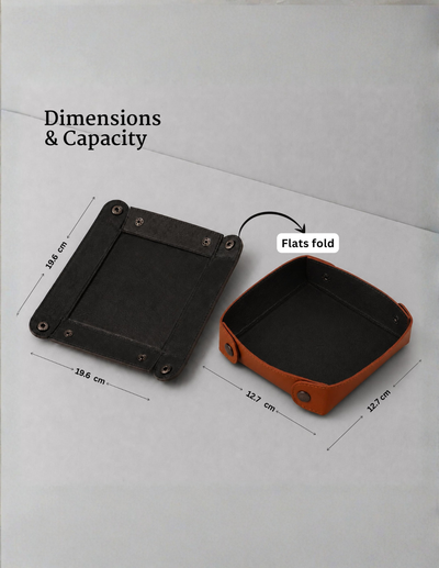 A product dimension diagram showing a square black tray-like item flat and folded, with overlaid text reading 'Dimensions & Capacity' and 'Flats fold' plus measurements in centimeters on a light gray background.
