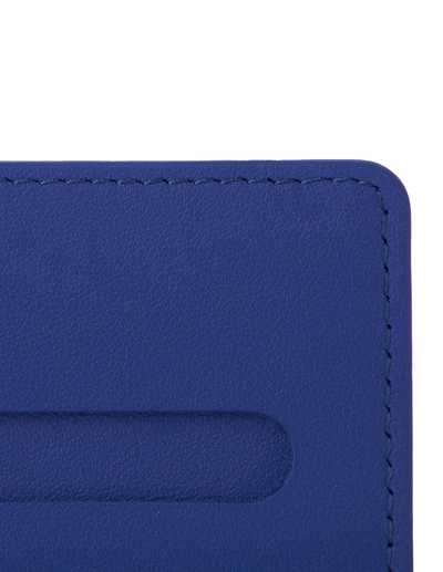 Close-up of a blue leather card holder or wallet corner with visible stitching and a card slot cutout on a white background.