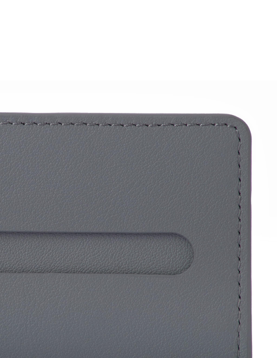 A close-up of a dark gray textured laptop lid corner against a plain light gray background.