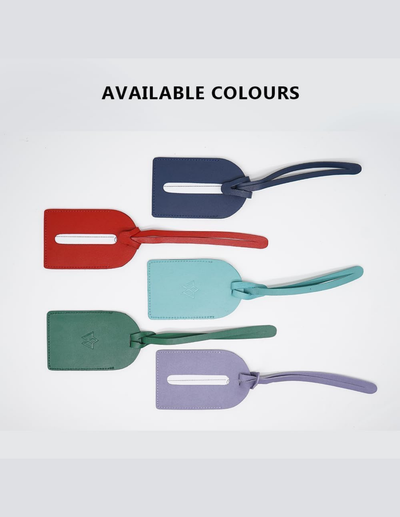 Four flat luggage tag-style pieces in different colors are shown on a light gray background with the text 'AVAILABLE COLOURS' above them. The colors are dark navy, red, mint/aqua, and lavender.